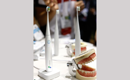 The Kolibree toothbrush sits on display at the International Consumer Electronics Show, Sunday, Jan. 5, 2014, in Las Vegas. Using Bluetooth wireless, the toothbrush senses how it’s moved and can send the information to an Android phone or iPhone and will be able to teach you to brush right and long enough. (AP)