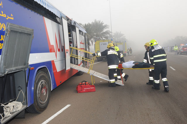 An injured motorist is shifted to the hospital by ambulance staff.