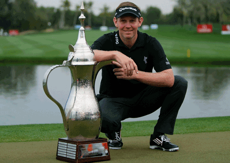 Stephen Gallacher of Scotland poses with his trophy after winning the 2014 Omega Dubai Desert Classic on February 2, 2014 in Dubai, United Arab Emirates. (AFP)