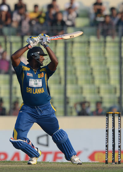Sri Lankan batsman Thisara Perera plays a shot during the first one-day international between Bangladesh and Sri Lanka at the Sher-e-Bangla National Cricket Stadium in Dhaka on February 17, 2014. (AFP)