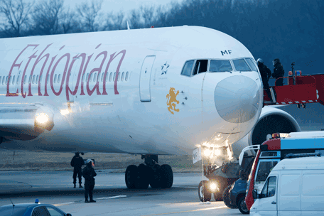 Police stand around the aircraft after passengers were evacuated from a hijacked Ethiopian Airlines Plane on the airport in Geneva, Switzerland, Monday, Feb. 17, 2014. A hijacked aircraft traveling from Addis Abeda, Ethiopia, to Rome, Italy, has landed at Geneva's international airport early Monday morning. Swiss authorities have arrested the hijacker. (AP)