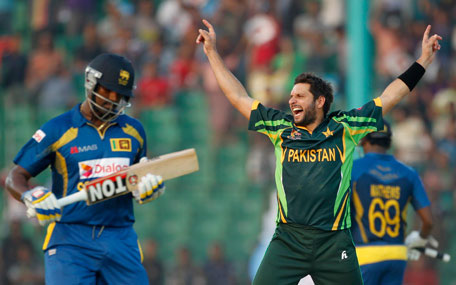 Sri Lanka's Thisara Perera (left) leaves the field as Pakistan's Shahid Afridi celebrates his dismissal during their one-day international cricket match at the 2014 Asia Cup in Fatullah on February 25, 2014. (REUTERS)