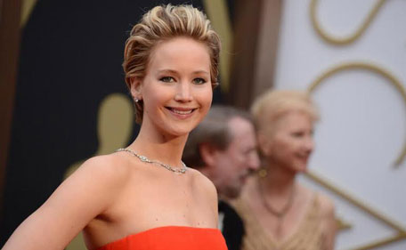 Jennifer Lawrence, best supporting actress nominee for her role in "American Hustle", wearing a Dior gown poses on arrival at the 86th Academy Awards in Hollywood, California. (REUTERS)