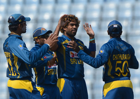 Sri Lankan bowler Lasith Malinga (second right) celebrates with his teammates after the dismissal of Pakistan cricketer Sharjeel Khan during the final of the Asia Cup one-day cricket tournament at the Sher-e-Bangla National Cricket Stadium in Dhaka on March 8, 2014. (AFP)