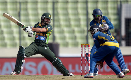Pakistan batsman Fawad Alam plays a shot as Sri Lankan wicketkeeper Kumar Sangakkara and fielder Ashan Priyanjan look on during the final of the Asia Cup one-day cricket tournament at the Sher-e-Bangla National Cricket Stadium in Dhaka on March 8, 2014. (AFP)
