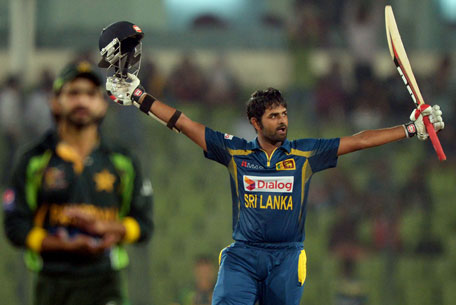 Sri Lankan batsman Lahiru Thirimanne celebrates after scoring a century as Pakistani fielder Fawad Alam claps during the final match of the Asia Cup one-day cricket tournament at the Sher-e-Bangla National Cricket Stadium in Dhaka on March 8, 2014. (AFP)