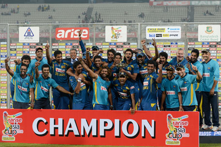 Sri Lanka's cricketers celebrate with the tournament trophy as they pose for a group photo following the presentation ceremony after winning the final match of the Asia Cup one-day cricket tournament at the Sher-e-Bangla National Cricket Stadium in Dhaka on March 8, 2014. (AFP)