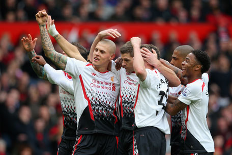 Steven Gerrard of Liverpool celebrates scoring the first goal with his team-mates during the Barclays Premier League match between Manchester United and Liverpool at Old Trafford on March 16, 2014 in Manchester, England. (GETTY)