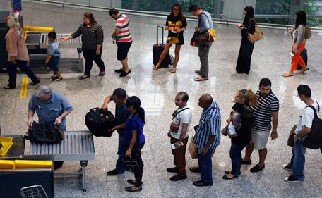 Passengers have their belongings screened by airport security at the departure hall of the Kuala Lumpur International Airport March 16, 2014. Prime Minister Najib Razak said on Saturday that the investigation would refocus on the crew and passengers of Flight MH370, after confirming that someone aboard appeared to have shut off the plane's communication systems before turning it away from its scheduled route from Kuala Lumpur to Beijing. (REUTERS)