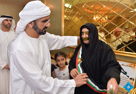 Mohammed bin Rashid granting Scarf to mother of martyr Tareq Al Shehi. (Supplied)