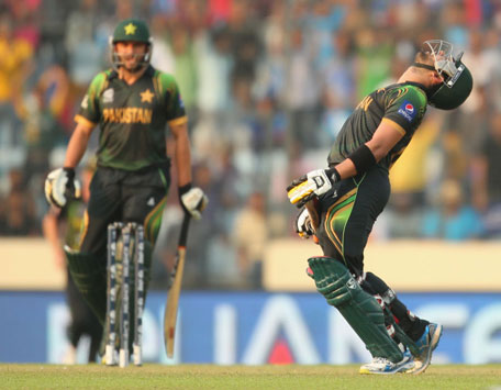 Umar Akmal (right) of Pakistan reacts after being dismissed for 94 as Shahid Afridi looks on during the ICC World Twenty20 Bangladesh 2014 match between Australia and Pakistan at Sher-e-Bangla Mirpur Stadium on March 23, 2014 in Dhaka, Bangladesh.  (GETTY)