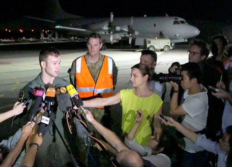 Royal Australian Air Force (RAAF) Flight Lieutenant Russell Adams speaks to members of the media in front of an AP-3C Orion plane at the RAAF Pearce Base in Perth March 23, 2014 after returning from the search for Malaysia Airlines flight MH370. New French satellite images show possible debris from the missing Malaysian airliner deep in the southern Indian Ocean, Malaysia said on Sunday, adding to growing signs that the plane may have gone down in remote seas off Australia.  (REUTERS)