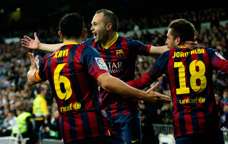 Andres Iniesta of Barcelona celebrates scoring the opening goal with team mates during the La Liga match between Real Madrid CF and FC Barcelona at the Bernabeu on March 23, 2014 in Madrid, Spain. (GETTY)