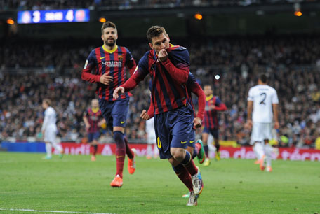 Lionel Messi of Barcelona celebrates scoring his team's fourth goal during the La Liga match between Real Madrid CF and FC Barcelona at the Bernabeu on March 23, 2014 in Madrid, Spain. (GETTY)
