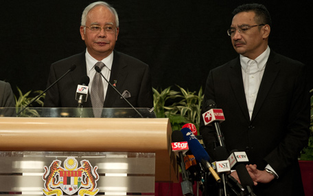 Malaysia's Prime Minister Najib Razak (L) delivers his statement on the missing Malaysia Airlines flight MH370 while Malaysian Minister of Defence and Acting Transport Minister Hishammuddin Hussein (R) looks on at the Putra World Trade Center (PWTC) in Kuala Lumpur on March 24, 2014. The missing Malaysia Airlines jet came down in the Indian Ocean, Prime Minister Najib Razak said March 24, as the airline reportedly told relatives it had been lost and that none on board survived. (AFP)