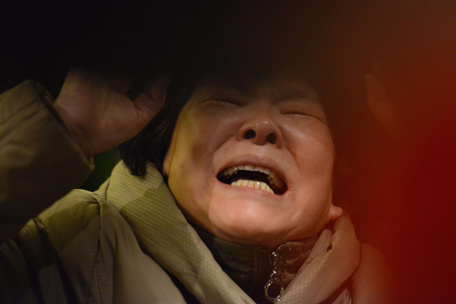 A relative of passengers on Malaysia Airlines flight MH370 cries after being told the news that the plane plunged into Indian Ocean in Beijing on March 24, 2014.  The missing Malaysia Airlines jet came down in the Indian Ocean, Prime Minister Najib Razak said March 24, as the airline reportedly told relatives it had been lost and that none on board survived.  (AFP)