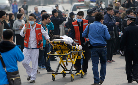 First-aid medical staff push a relative, of a passenger aboard Malaysia Airlines MH370, who passed out during a protest outside the Malaysian Embassy, in Beijing March 25, 2014. Angry relatives of Chinese passengers aboard the missing plane protested on Tuesday outside the Malaysian Embassy, demanding an explanation from the airline and accusing the government in Kuala Lumpur of "cheating" them. (REUTERS)