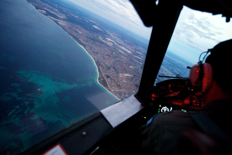 This picture taken on March 24 shows crew members on board an RAAF AP-3C Orion crossing the coast of Perth, having just completed an 11 hour search mission for missing Malaysia Airways flight MH370 before landing at the RAAF Pearce airbase in Perth. The air and sea search for Malaysia Airlines flight MH370 that crashed in the Indian Ocean was suspended on March 25 due to gale force winds, rain and big waves, the Australian Maritime Safety Authority said. (AFP)