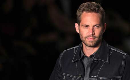 FILE: US actor Paul Walker presents a creation from Colcci's 2013/2014 summer collection during Sao Paulo Fashion Week in this March 21, 2013 file photo. A fiery car accident last year that killed "Fast & Furious" actor Paul Walker. (REUTERS)