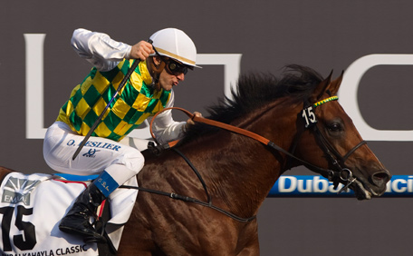 Olivier Peslier riding Rabah de Carrere from the United Arab Emirates reacts as he races past the finish line during the Kahayla Classic race at the Dubai World Cup at Meydan Racecourse in Dubai March 29, 2014.  (REUTERS)