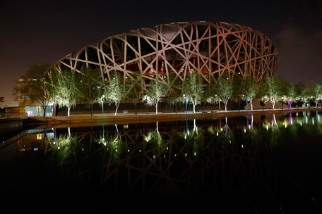 The National Stadium, also known as the "Bird's Nest", is seen reflected in a lake during Earth Hour at the Olympic Park in Beijing, March 29, 2014. Lights go off around the world at 8.30pm local time in a show of support for renewable energy during Earth Hour, an event organised since 2007 to promote a sustainable future for the planet.  (REUTERS)