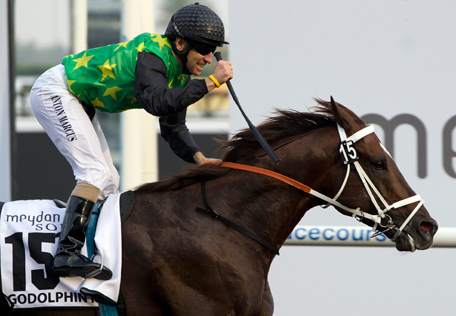 Anton Marcus riding Variety Club of South Africa reacts as he races past the finish line during the Godolphin Mile race during the Dubai World Cup at Meydan Racecourse in Dubai March 29, 2014.  (REUTERS)