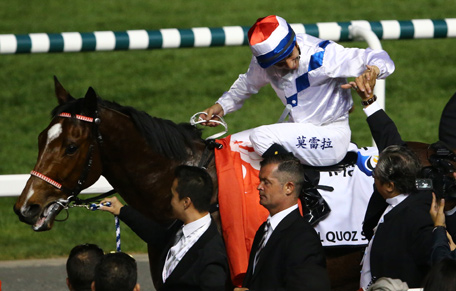 Brazilian jockey Joao Moreira on Amber Sky is congratulated after winning the al Quoz Sprint race held on Dubai World Cup day on March 29, 2014 at Meydan racecourse in Dubai. A cosmopolitan gathering of horses from seven different countries contest the US$10 million Emirates Dubai World Cup at Meydan racecourse. (AFP)