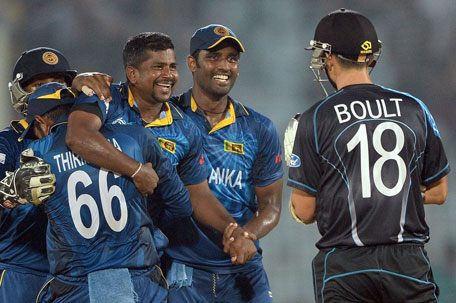 Sri Lanka bowler Rangana Herath (centre) celebrates the wicket of New Zealand batsman Trent Boult with teammates during the ICC World Twenty20 tournament cricket match between New Zealand and Sri Lanka at the Zahur Ahmed Chowdhury Stadium in Chittagong on March 31, 2014. (AFP)
