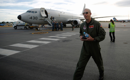 A U.S. Navy P8 Poseidon aircraft pilot, Lt Commander David Mims is pictured in front of the plane upon his return from a search flight for Malaysia Airlines flight MH370 over the Indian Ocean, at Perth International Airport March 31, 2014. Of all the 20 aircraft and ships out scouring the vast Indian Ocean for debris from Malaysia Airlines flight MH370, the U.S. Navy's P-8 Poseidon seems perhaps the most likely to help unlock modern aviation's most confounding mystery. Picture taken March 31, 2014. (REUTERS)