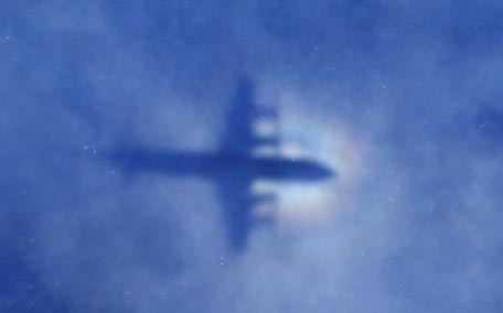 This shadow of a Royal New Zealand Air Force P3 Orion aircraft is seen on low cloud cover while it searches for missing Malaysia Airlines flight MH370, over the Indian Ocean. (AFP)