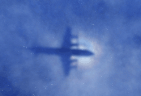 This shadow of a Royal New Zealand Air Force P3 Orion aircraft is seen on low cloud cover while it searches for missing Malaysia Airlines flight MH370, over the Indian Ocean on March 31, 2014. (AFP)