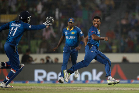 Sri Lanka's Seekkuge Prasanna (right) celebrates the wicket of West Indies' Lendl Simmons during their ICC Twenty20 Cricket World Cup semifinal match in Dhaka, Bangladesh, Thursday, April 3, 2014. (AP)