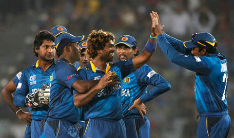 Sri Lanka's fielders congratulate bowler Lasith Malinga (third right) after he dismissed West Indies' Dwayne Smith during their semi-final match in the ICC Twenty20 World Cup at the Sher-E-Bangla National Cricket Stadium in Dhaka April 3, 2014. (REUTERS)