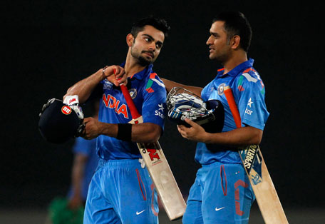 India's Virat Kohli and captain MS Dhoni (right) come off the field after India won the semi-final match against South Africa in the ICC Twenty20 World Cup at the Sher-E-Bangla National Cricket Stadium in Dhaka April 4, 2014. (REUTERS)