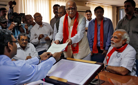 A leader of India's main opposition Bharatiya Janata Party (BJP) Lal Krishna Advani (C) hands his nomination papers to an election officer as BJP prime ministerial candidate Narendra Modi (front R) looks on, ahead of the general election, at Gandhinagar in the western Indian state of Gujarat April 5, 2014. India, the world's largest democracy, will hold its general election in nine stages staggered between April 7 and May 12. (REUTERS)