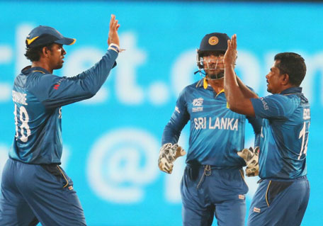 Rangana Herath of Sri Lanka is congratulated by his teammates after dismissing Rohit Sharma of India during the Final of the ICC World Twenty20 Bangladesh 2014 between India and Sri Lanka at Sher-e-Bangla Mirpur Stadium on April 4, 2014 in Dhaka, Bangladesh. (GETTY)