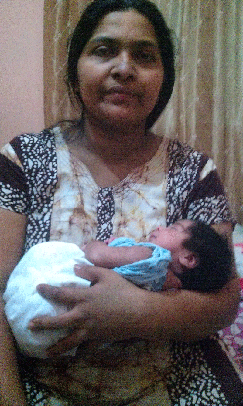 Nisha, who suffered a heart attack in the operation theatre immediately after delivery a baby, holding her newborn.