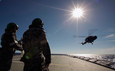 Crew aboard the Australian Navy ship HMAS Success watch as a helicopter participates in a Replenishment at Sea evolution with the Royal Malaysian Navy ship KD LEKIU in the southern Indian Ocean during the continuing search for the missing Malaysian Airlines flight MH370 in this picture released by the Australian Defence Force April 7, 2014. Australian officials said on Monday signals picked up by a black box detector attached to an Australian ship searching for Malaysia Airlines Flight MH370 were consistent with aircraft flight recorders. "Clearly, this is a most promising lead," Angus Houston, head of the Australian agency coordinating the search, told a news conference in Perth. Houston, a retired air chief marshal, said two signals had been detected off Australia's northwest coast. Confirmation of whether the signals were emitted from the Malaysian plane, missing since March 8 with 239 people on board, could take several days, Houston said. (REUTERS)
