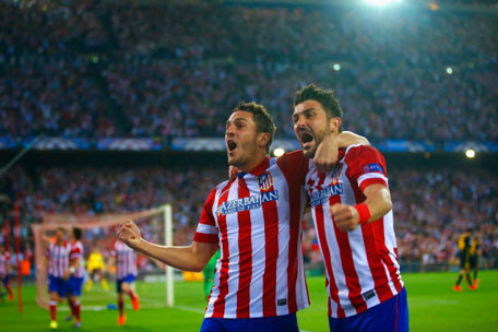 Koke of Club Atletico de Madrid celebrates scoring the opening goal with David Villa of Club Atletico de Madrid during the UEFA Champions League Quarter Final second leg match between Club Atletico de Madrid and FC Barcelona at Vicente Calderon Stadium on April 9, 2014 in Madrid, Spain. (GETTY)
