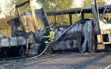 Firefighters douse the wreckage at the scene of a collision of a tractor-trailer and a tour bus on Interstate 5 near Highway 32 near Orland, California. (REUTERS)