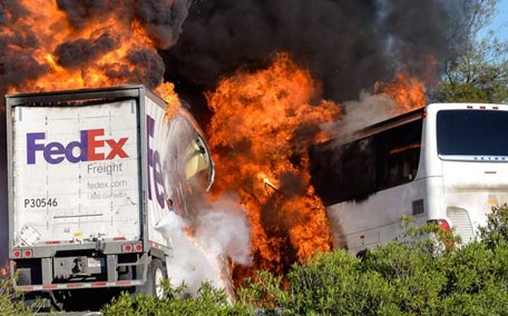 Massive flames are seen devouring both vehicles just after the crash, and clouds of smoke billowed into the sky. (AP)
