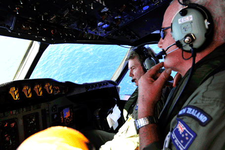 Royal New Zealand Air Force (RNZAF) co-pilot squadron leader Brett McKenzie, left, and Flight Engineer Trent Wyatt sit in the cockpit aboard a P-3 Orion on route to search over the southern Indian Ocean looking for missing Malaysia Airlines flight MH370 Friday, April 11, 2014. Authorities are confident that signals detected deep in the Indian Ocean are from the missing Malaysian jet's black boxes, Australia's Prime Minister Tony Abbott said Friday, raising hopes they are close to solving one of aviation's most perplexing mysteries.  (AP)