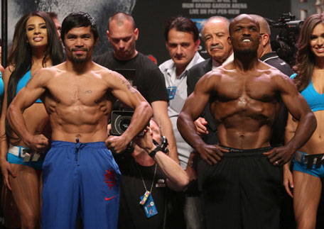 Manny Pacquiao and Timothy Bradley flex during a weigh in prior to their WBO World Welterweight Title bout at the MGM Grand Garden Arena on April 11, 2014 in Las Vegas, Nevada. (GETTY)