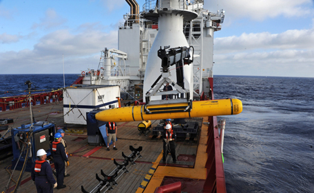 This handout image taken on April 14, 2014 and received on April 15, 2014 from the US Navy shows operators aboard ADF Ocean Shield moving US Navy’s Bluefin-21 into position for deployment in the search of missing Malaysia Airlines flight MH370. Using side scan sonar, the Bluefin will descend to a depth of between 4,000 and 4,500 meters, approximately 35 meters above the ocean floor and will spend up to 16 hours at this depth collecting data, before potentially moving to other likely search areas. A mini-sub hunting for Malaysian jet MH370 aborted its first search of the remote Indian Ocean seabed after just six hours because the water was deeper than its operating limits, officials said on April 15, 2014. (AFP)