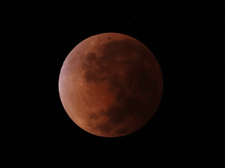 The moon is seen turning red, during a lunar eclipse over Asuncion, Paraguay,Tuesday April 15, 2014. Tuesday's eclipse is the first of four total lunar eclipses that will take place between 2014 to 2015.(AP)