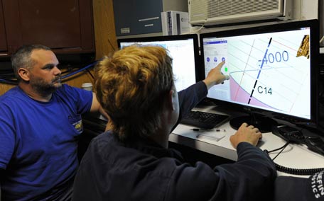 Scott Woodard (L) and Craig Turner from Phoenix International monitoring the Artemis' depth and speed as the Autonomous Underwater Vehicle scans the ocean floor for missing Malaysia Airlines flight MH370 in the southern Indian Ocean. (AFP)