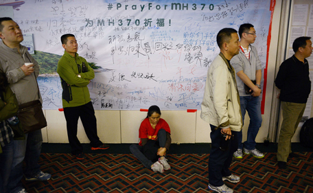 A Chinese relative (C) of passengers on the missing Malaysia Airlines flight MH370 waits for new information at the Metro Park Hotel in Beijing on April 21, 2014. The hunt for physical evidence that the Malaysia Airlines jet crashed in the Indian Ocean more than three weeks ago has turned up nothing, despite a massive operation involving seven countries and repeated sightings of suspected debris. (AFP)