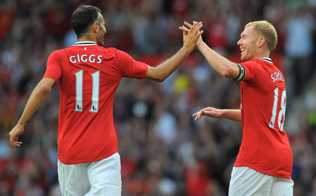 Manchester United's midfielder Paul Scholes (right) celebrates with Ryan Giggs after scoring during the Paul Scholes testimonial football match between Manchester United and New York Cosmos at Old Trafford in Manchester, England. (AFP)