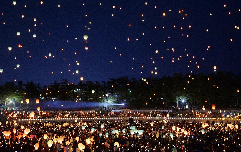 In this Saturday, April 26, 2014 photo, Buddhists release paper lanterns in a service for cherishing the memory of deceased persons and safe return of passengers aboard the sunken ferry Sewol during the Lotus Lantern Festival for the upcoming birthday of Buddha on May 6, at a baseball stadium in Daegu, South Korea. South Korean President Park Geun-hye accepted her Prime Minister Chung Hong-won's resignation Sunday, April 27, 2014, over the government's handling of the deadly ferry sinking, although she didn't set a last day in office. (AP Photo/Yonhap) KOREA OUT