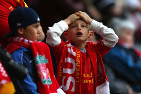 A young Liverpool fan reacts during the Barclays Premier League match between Liverpool and Chelsea at Anfield on April 27, 2014 in Liverpool, England. (GETTY)